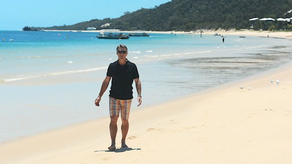 Andy Bichel walks along Tangalooma beach